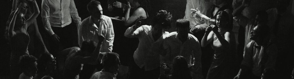 Wedding guests dancing and celebrating during the evening reception